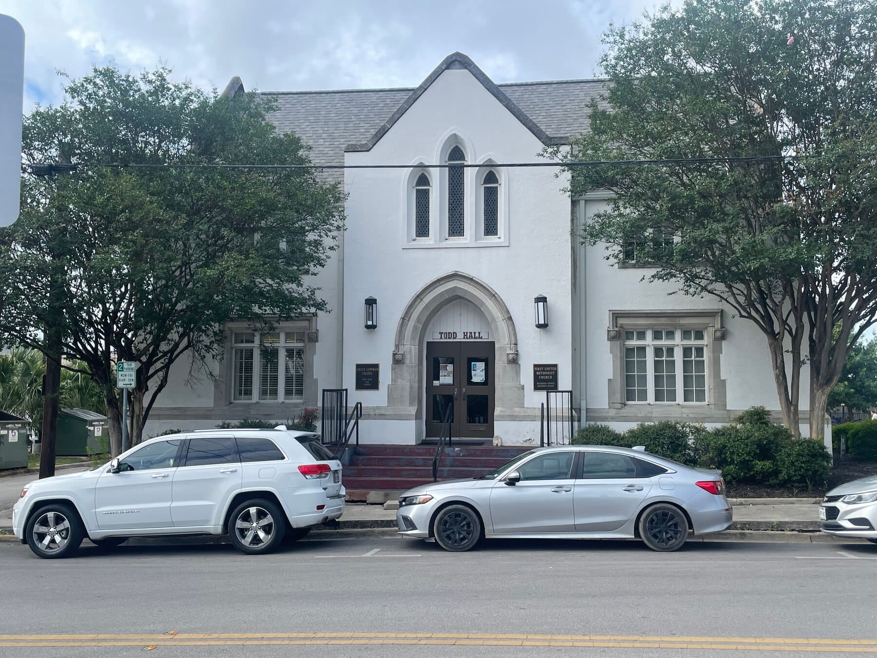 Todd Hall — the white Gothic Revival building with a pointed-arch entrance and the words 'Todd Hall' above the doors.